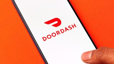 A man open DoorDash Mobile Apps to permanently delete DoorDash account concept