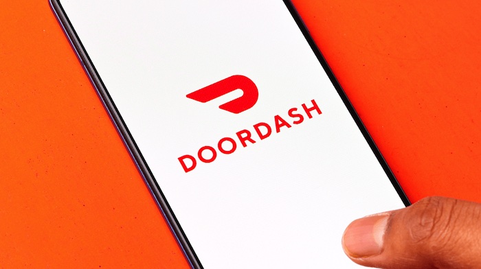 A man open DoorDash Mobile Apps to permanently delete DoorDash account concept